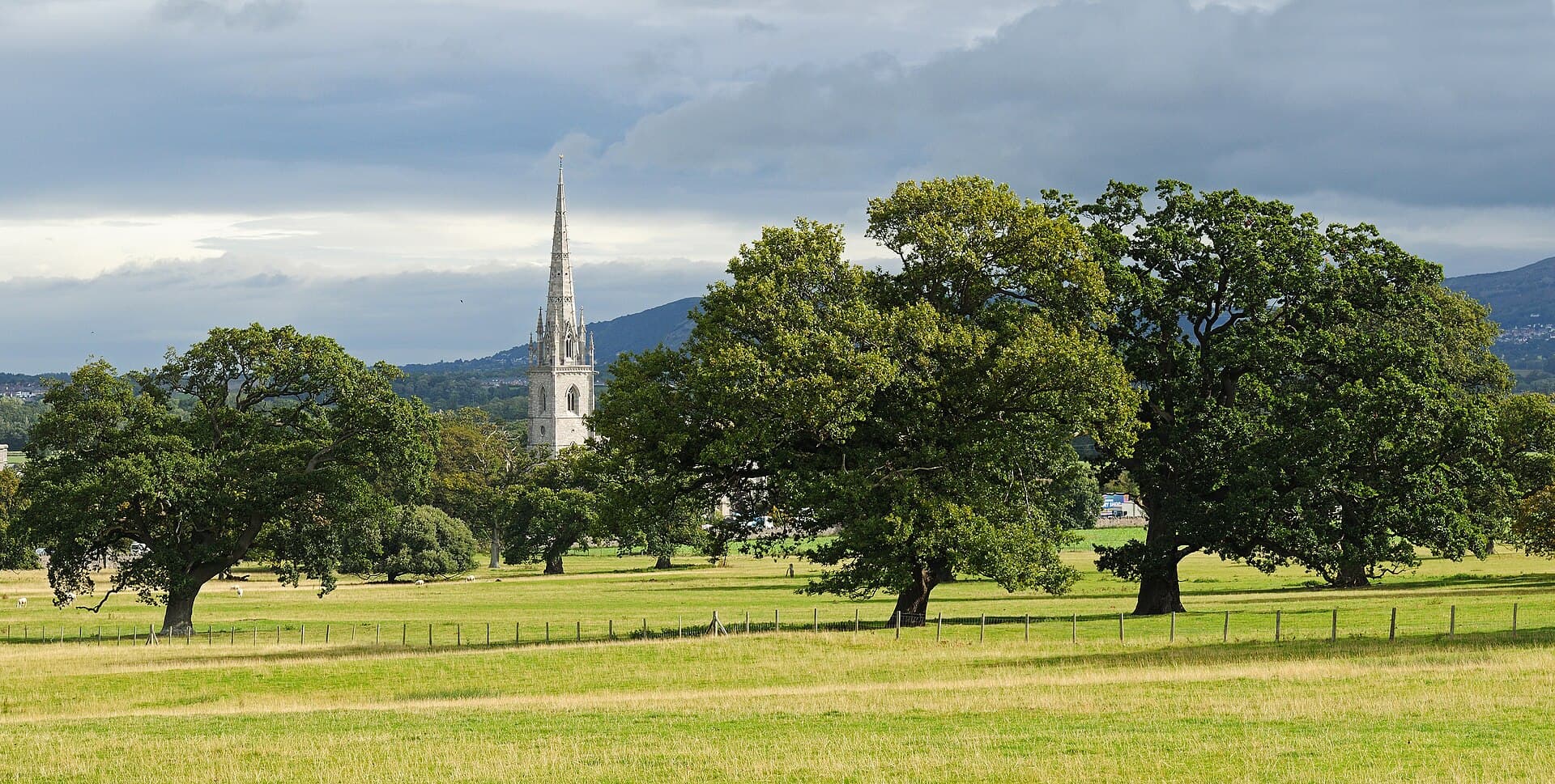 The white spire of the Marble Church rising over parkland near Bodelwyddan