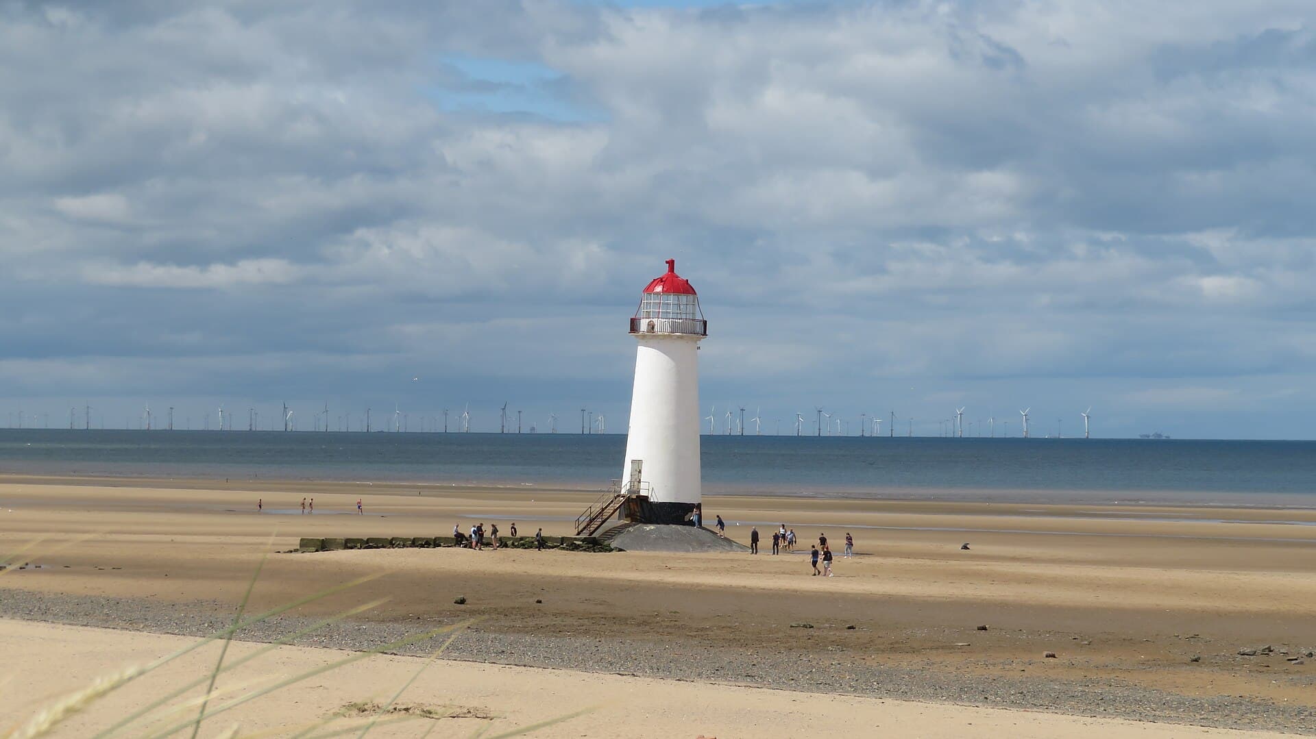 The red-capped Point of Ayr lighthouse standing on the sand at Talacre, by the Gronant dunes