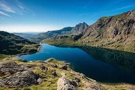 A mountain lake ringed by the peaks of Snowdonia / Eryri